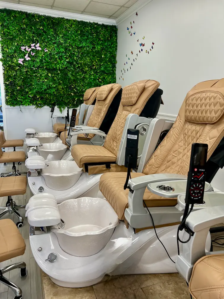 Pedicure chairs and green wall at Hollywood Nails